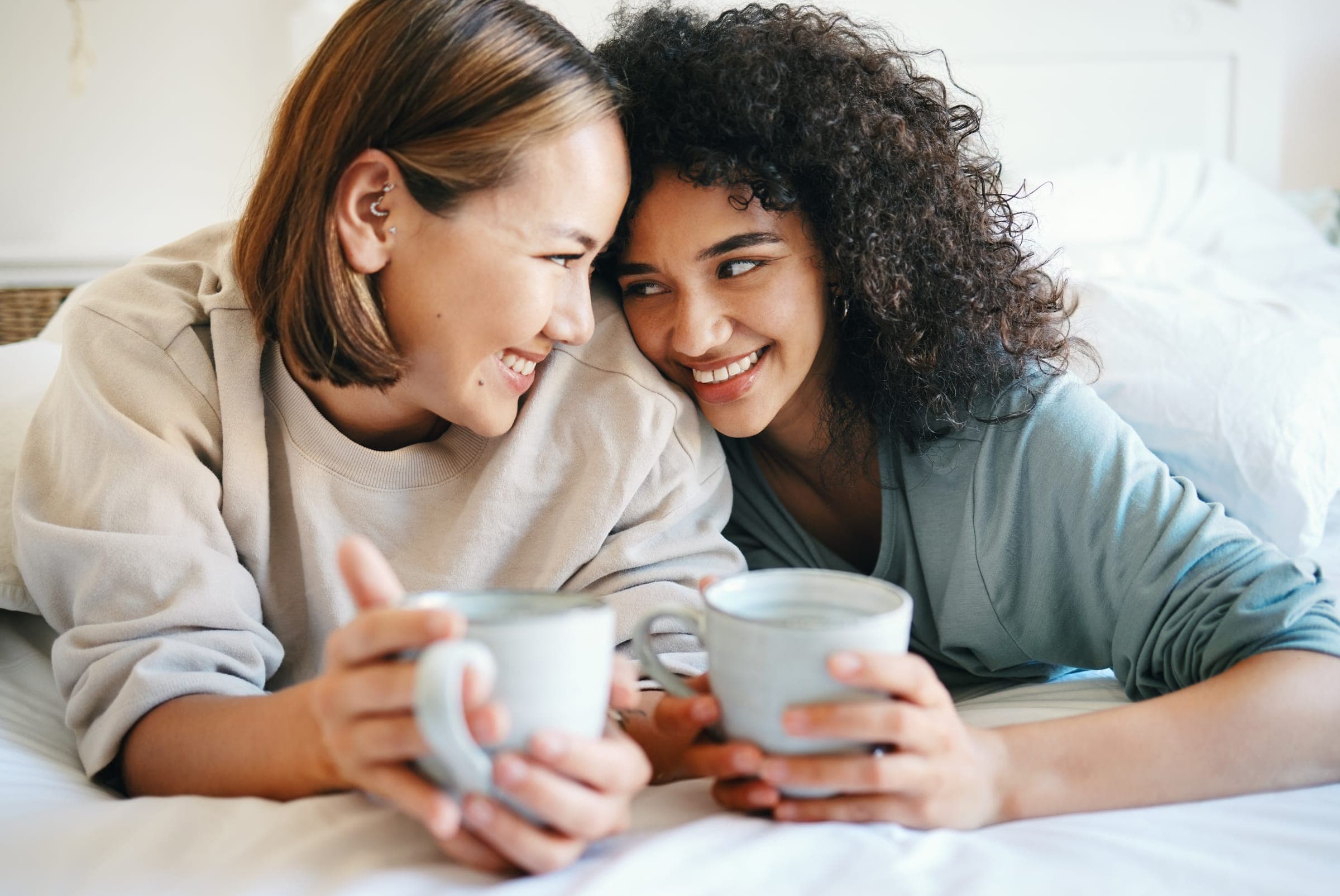 Two people sharing a quiet morning at home with mugs in hand.